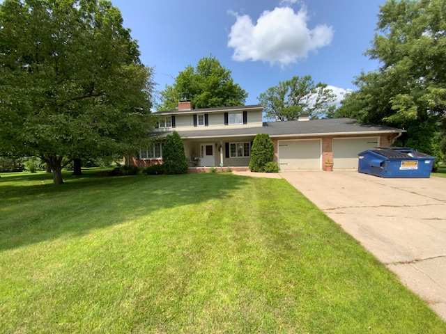 view of front of house with a garage and a front lawn