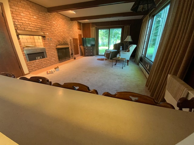 living room with radiator, baseboard heating, beam ceiling, carpet, and a brick fireplace