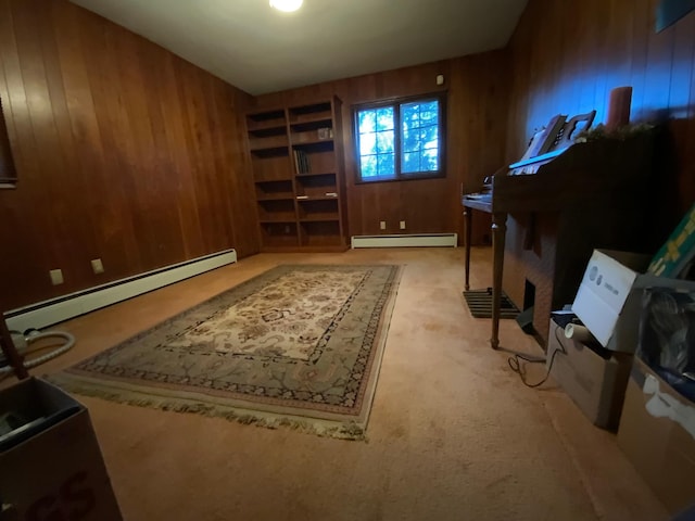 carpeted office with a baseboard heating unit and wood walls