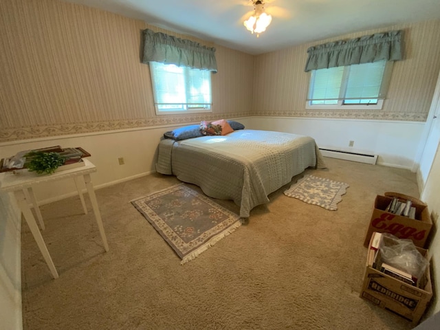 bedroom featuring a baseboard heating unit and carpet flooring