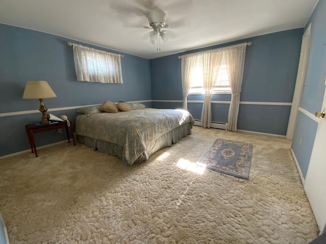 carpeted bedroom featuring a baseboard radiator and ceiling fan