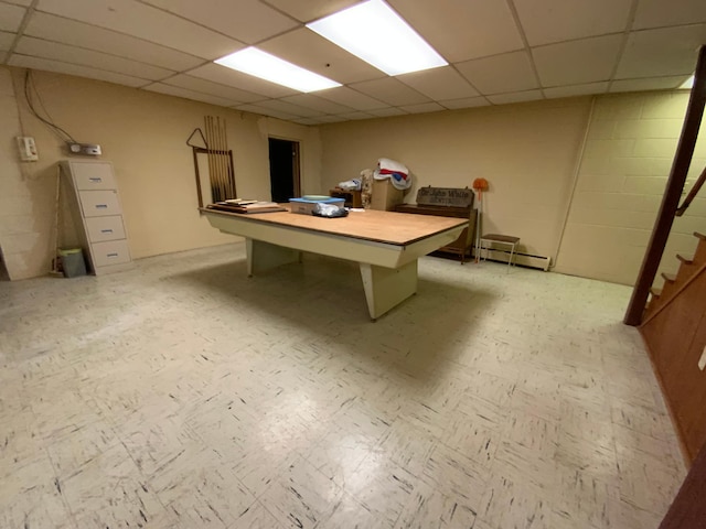 recreation room featuring a baseboard radiator and a paneled ceiling