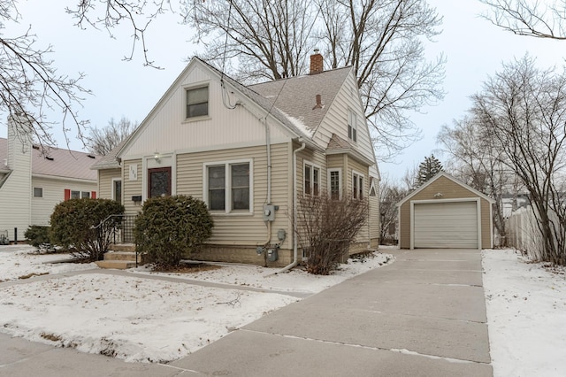 view of front of home featuring a garage and an outbuilding