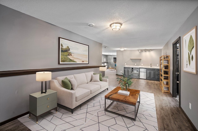 living room featuring light hardwood / wood-style flooring and a textured ceiling