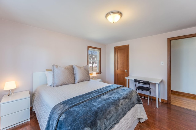 bedroom with dark hardwood / wood-style floors