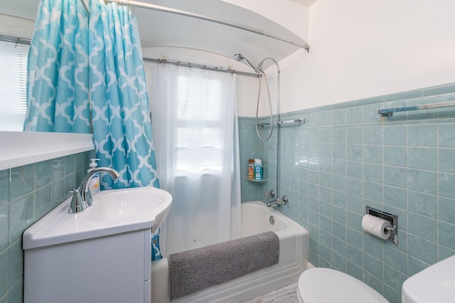 full bathroom featuring toilet, vanity, shower / bathtub combination with curtain, and tile walls