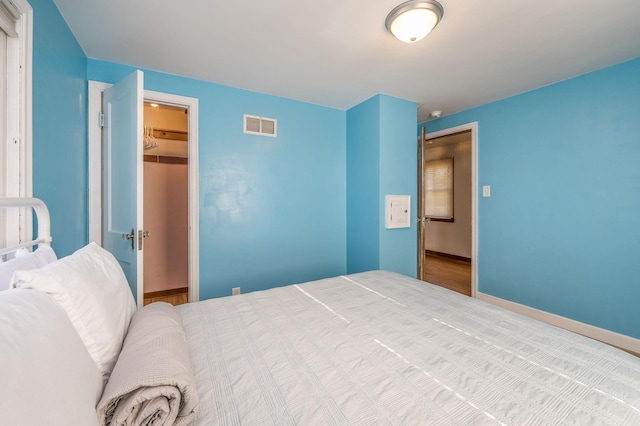 bedroom with a spacious closet and a closet