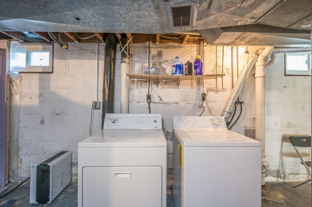 washroom with a healthy amount of sunlight and washer and dryer