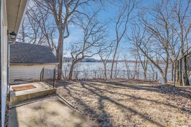 view of yard featuring a water view and a patio area