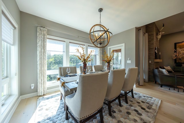 dining room with light hardwood / wood-style floors and a chandelier