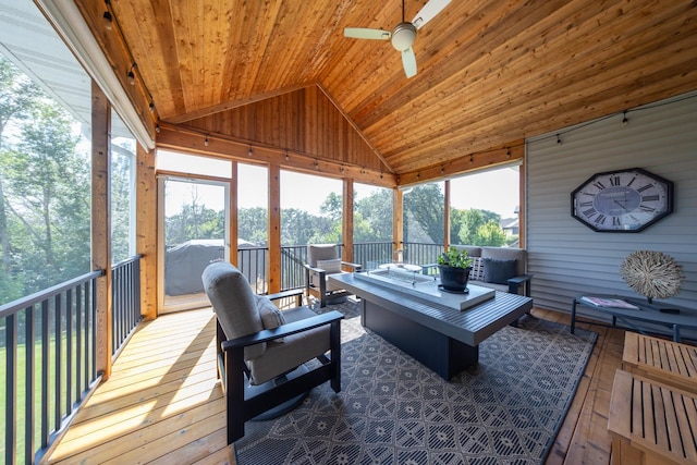 sunroom / solarium with vaulted ceiling, wooden ceiling, ceiling fan, and plenty of natural light