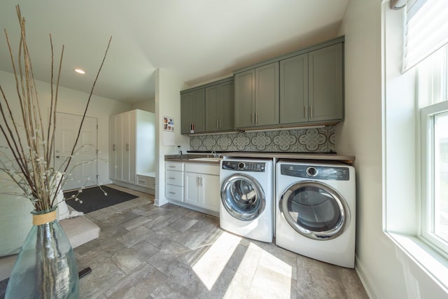 laundry room with cabinets, sink, and independent washer and dryer