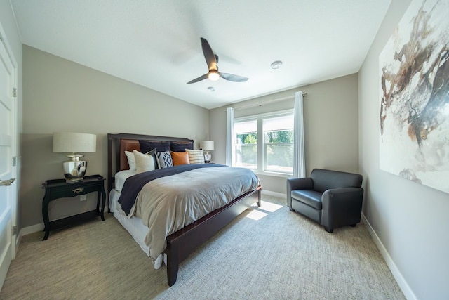 bedroom with lofted ceiling, light colored carpet, and ceiling fan