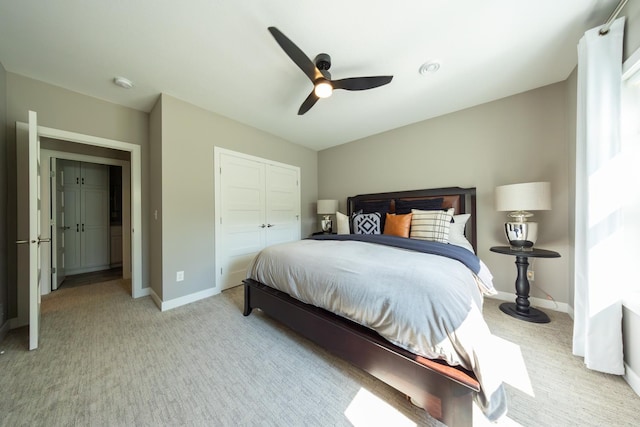 carpeted bedroom featuring ceiling fan and a closet