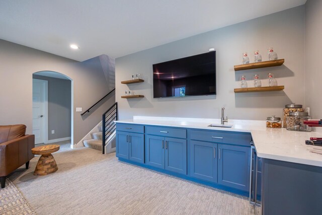 carpeted living room with sink