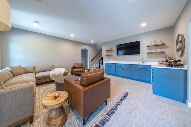 carpeted living room featuring wet bar