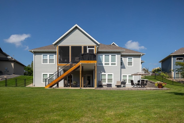 back of property featuring a patio, a sunroom, and a lawn