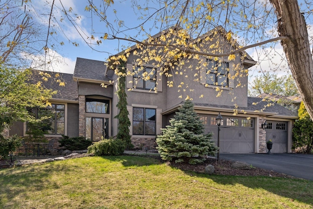 view of front of property with a garage, a front lawn, aphalt driveway, stucco siding, and a shingled roof