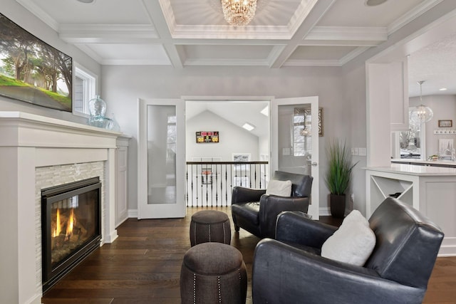 living room featuring dark wood-style flooring, coffered ceiling, a glass covered fireplace, and beam ceiling