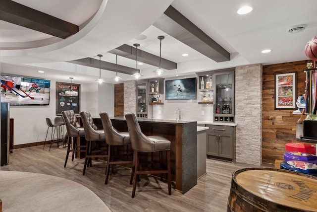 bar featuring recessed lighting, wet bar, and light wood finished floors