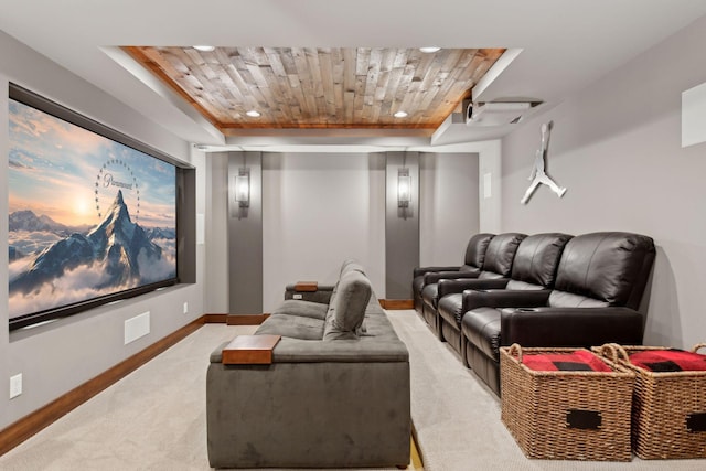 home theater featuring light colored carpet, baseboards, and a tray ceiling