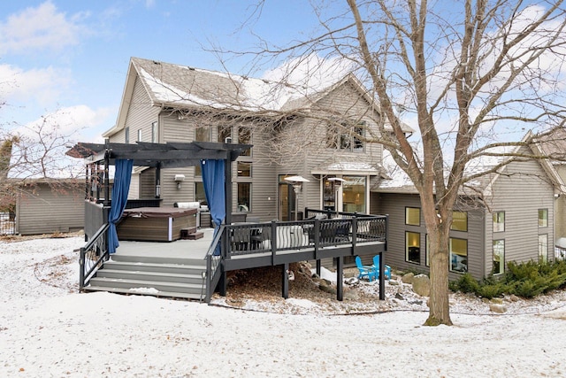 view of front of house with a hot tub, a pergola, and a deck