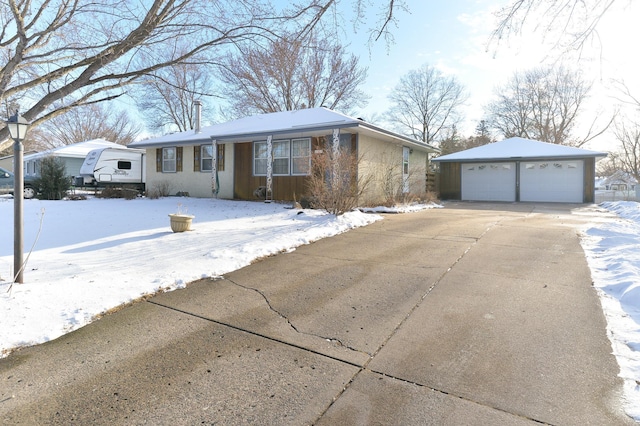 single story home featuring an outbuilding and a garage