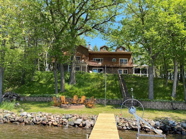 dock area featuring a fire pit and a water view