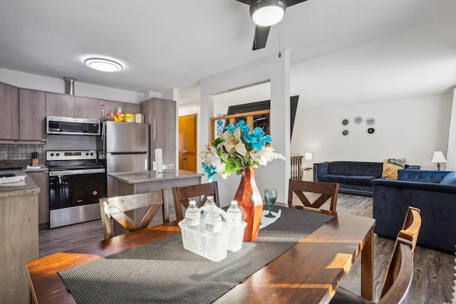 dining area with dark hardwood / wood-style flooring, a textured ceiling, and ceiling fan