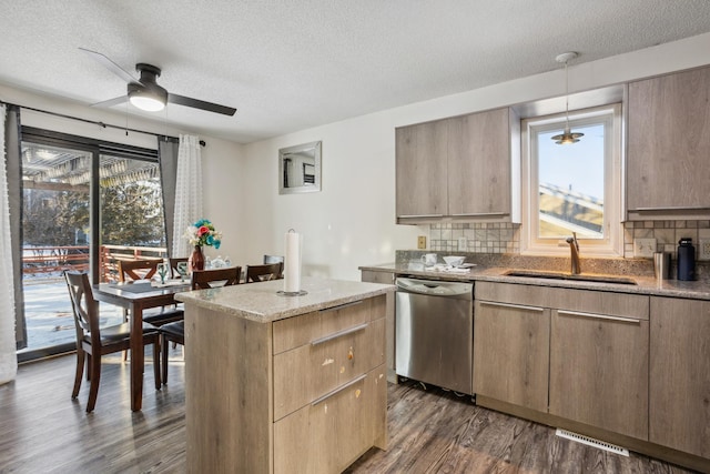 kitchen with dark wood-type flooring, sink, decorative light fixtures, stainless steel dishwasher, and backsplash