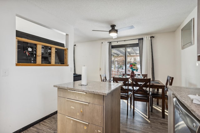 kitchen with dark wood-type flooring, a textured ceiling, stainless steel dishwasher, ceiling fan, and light stone countertops