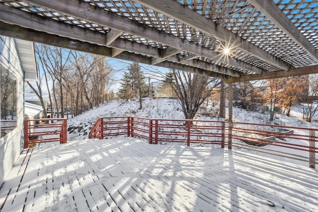 snow covered deck with a pergola