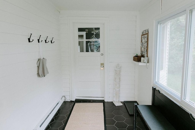 mudroom with a baseboard radiator and dark tile patterned flooring