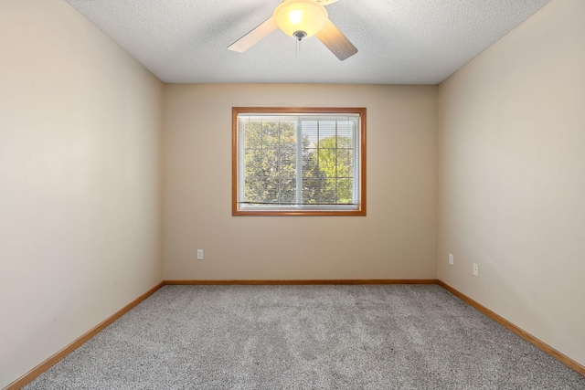 carpeted spare room featuring ceiling fan and a textured ceiling