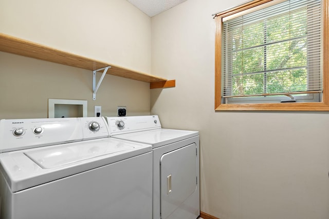 clothes washing area featuring washer and clothes dryer