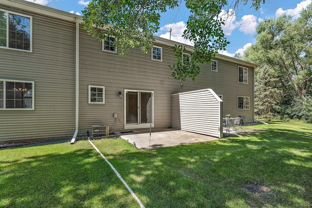 rear view of house featuring a yard, a patio, and central air condition unit