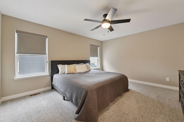 bedroom featuring light carpet and ceiling fan