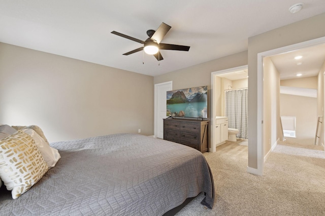 carpeted bedroom with ceiling fan and ensuite bath