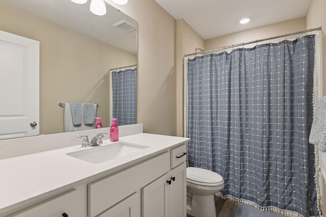 bathroom with vanity, toilet, and a shower with shower curtain