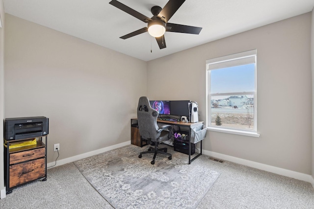 carpeted office space with ceiling fan