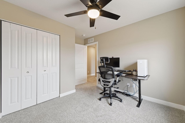 office space with ceiling fan and light carpet