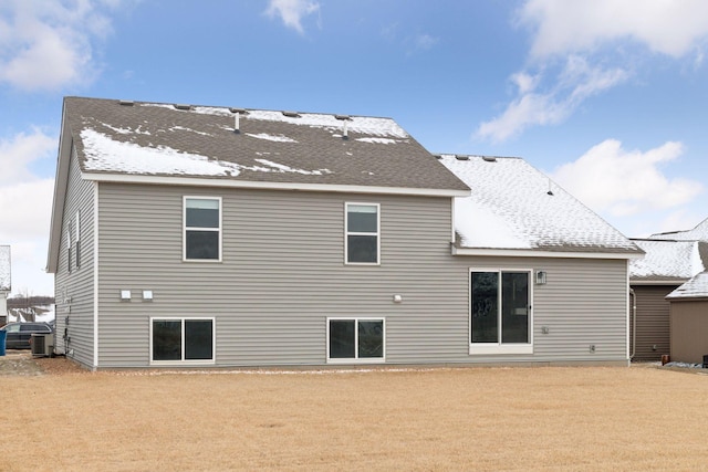 back of property with cooling unit and a yard