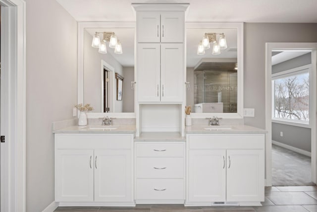 full bath featuring double vanity, a stall shower, and a sink