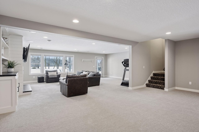 living room featuring stairs, light colored carpet, and baseboards