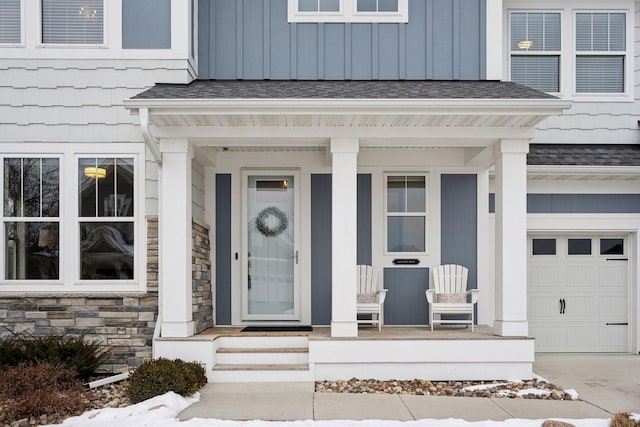 entrance to property with a garage and covered porch