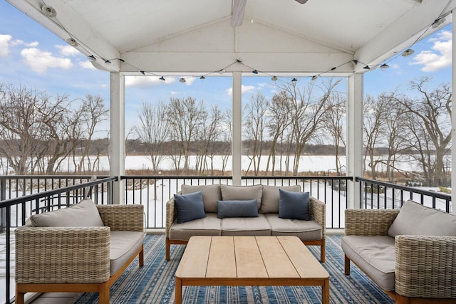 snow covered deck with an outdoor hangout area and a water view