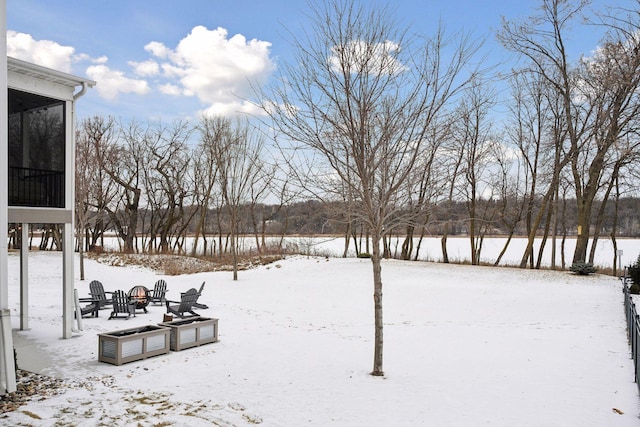 yard covered in snow with a fire pit