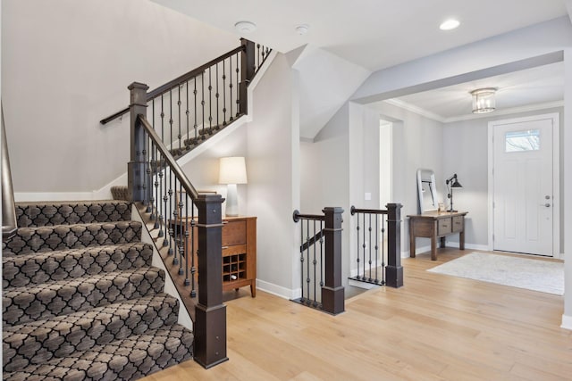 entryway with recessed lighting, baseboards, wood finished floors, and crown molding