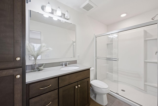 full bathroom featuring tile patterned floors, visible vents, toilet, a stall shower, and vanity