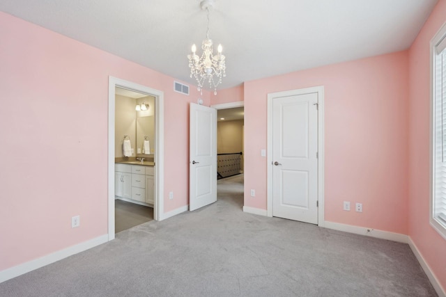 unfurnished bedroom with visible vents, baseboards, carpet, and a notable chandelier